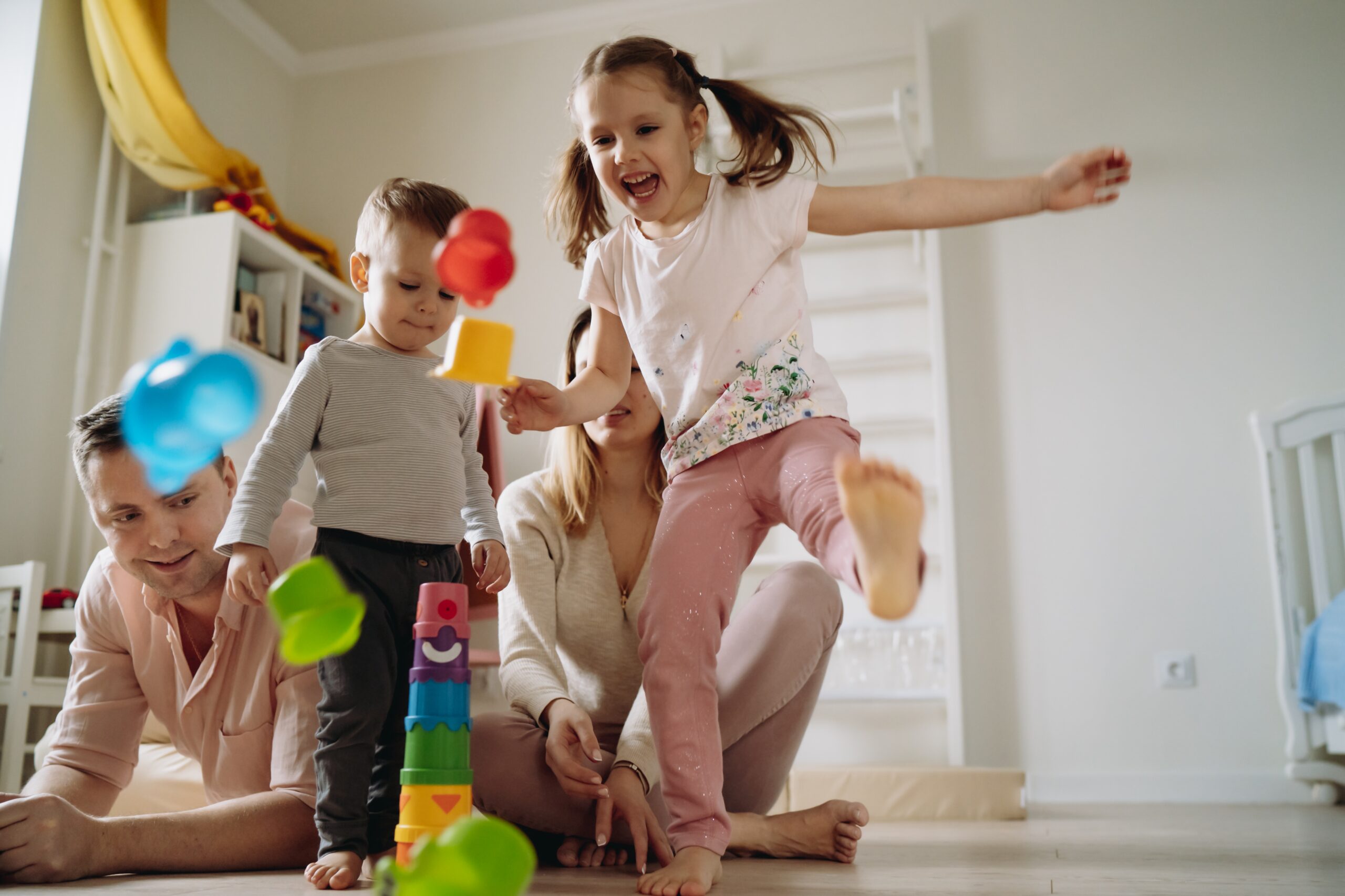 family-play-at-home-girl-breaking-toy-tower-2025-03-08-15-34-36-utc